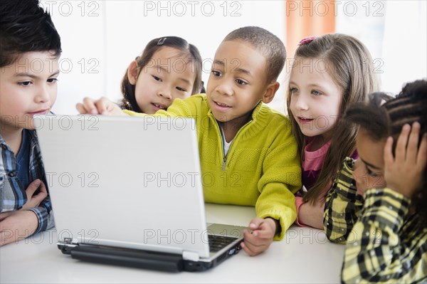 Children using laptop together