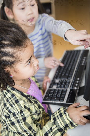 Children using computer together