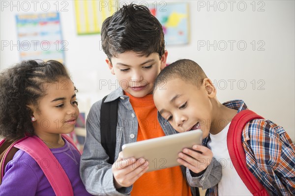 Students using digital tablet in classroom