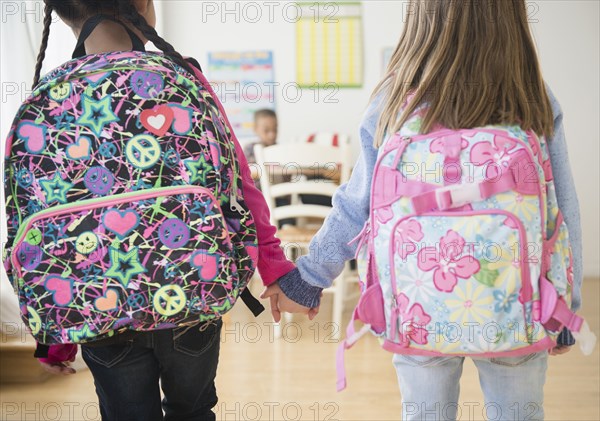 Students holding hands in classroom