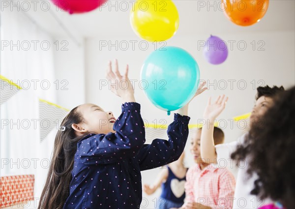 Children playing with colorful balloons at party