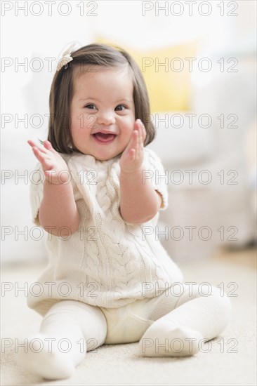 Hispanic toddler with Down syndrome playing