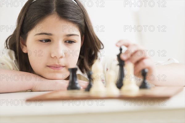 Hispanic girl playing chess
