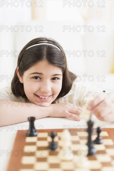 Hispanic girl playing chess