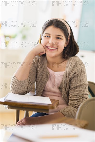 Hispanic girl smiling in classroom