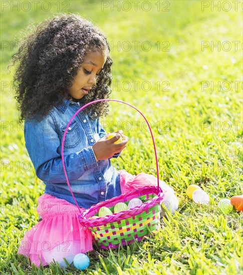 Mixed race girl hunting for Easter eggs
