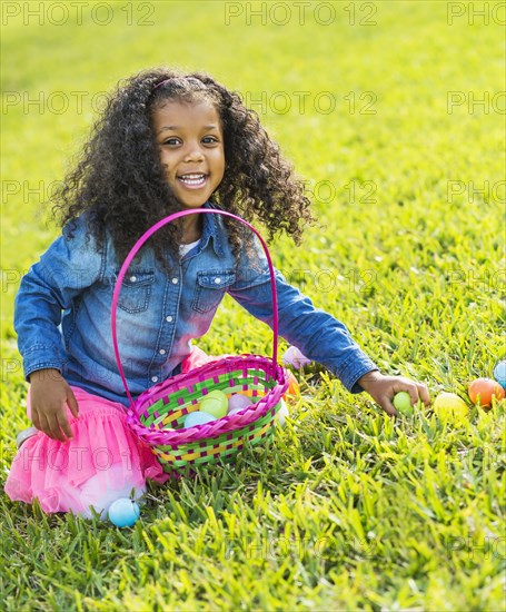 Mixed race girl hunting for Easter eggs