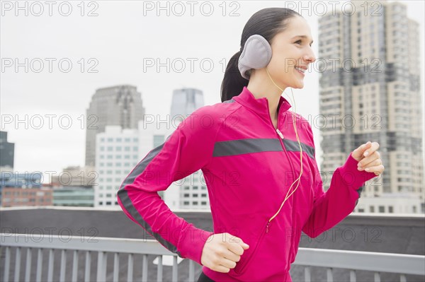 Caucasian woman jogging in city