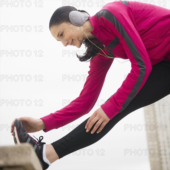 Caucasian woman stretching leg
