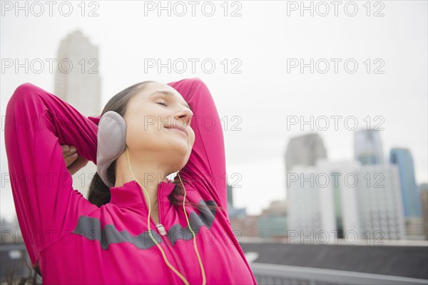 Caucasian woman stretching in city