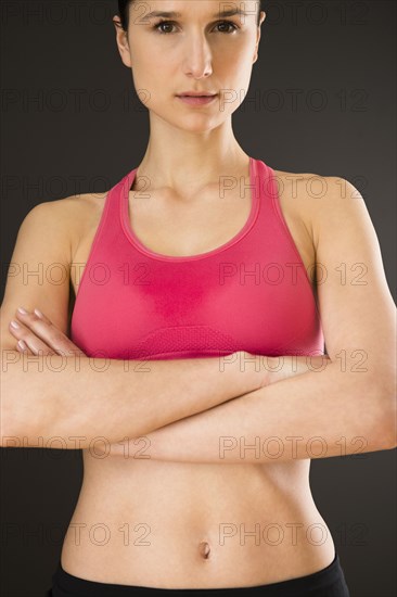 Caucasian woman with bare stomach wearing sports clothing