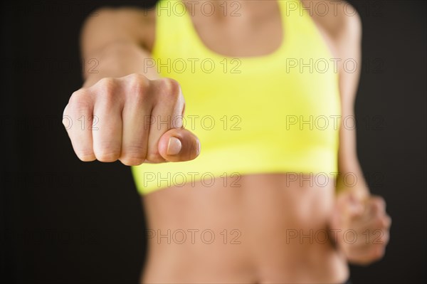 Caucasian woman with bare stomach punching