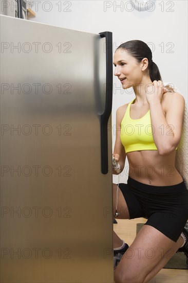 Caucasian woman searching refrigerator for food