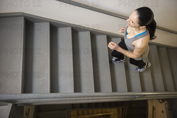 Caucasian woman running up stairs