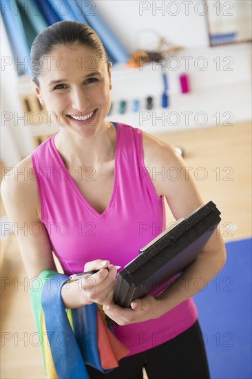 Caucasian woman holding clipboard