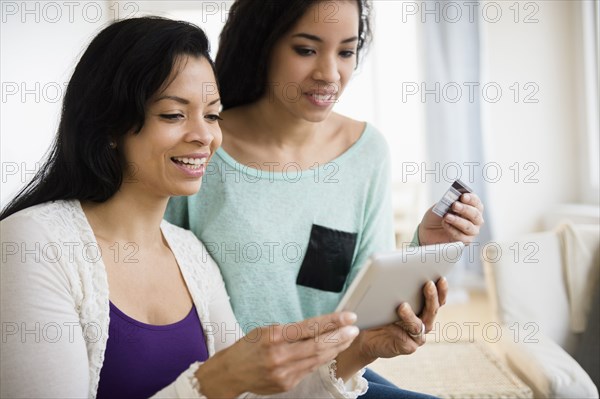 Mother and daughter using tablet computer together