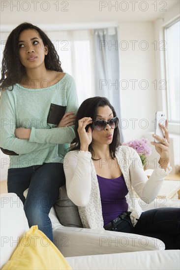 Teenage girl rolling her eyes at mother