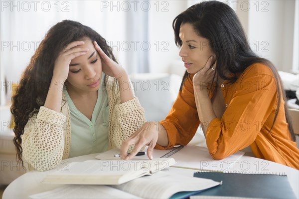 Mother helping daughter with homework