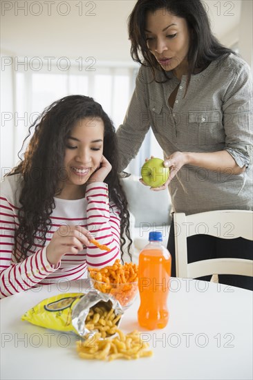 Mother offering daughter healthy snack