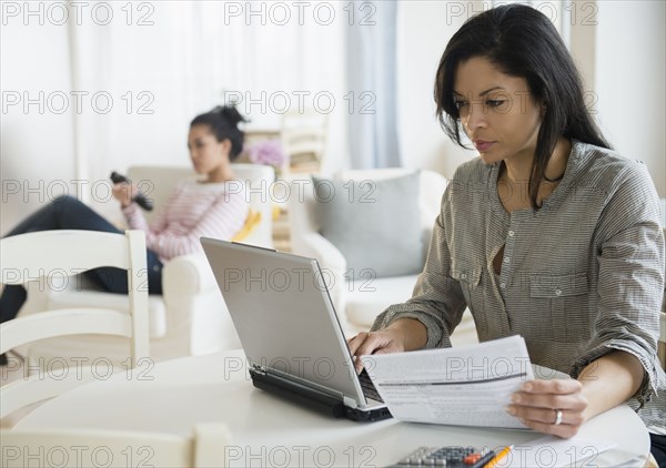 Woman paying bills online