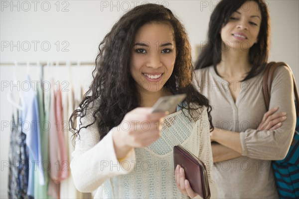 Teenage girl paying with credit card in store