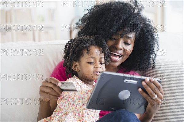 Mother and daughter shopping on tablet computer