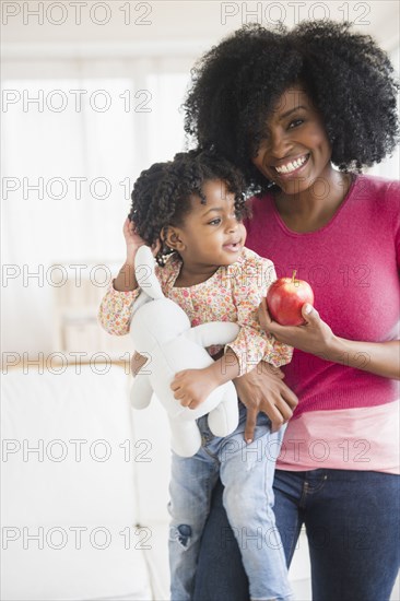 Mother and daughter with apple