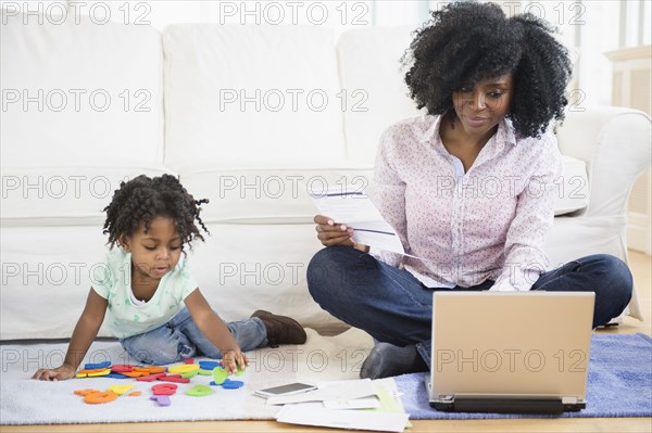 Mother and daughter relaxing in living room