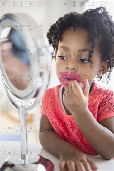 African American girl applying makeup