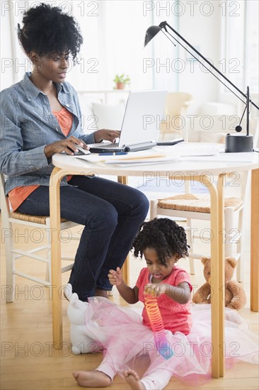 Mother and daughter relaxing in living room