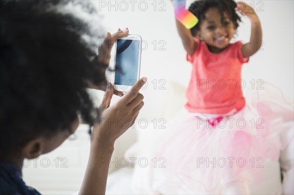 Mother photographing daughter