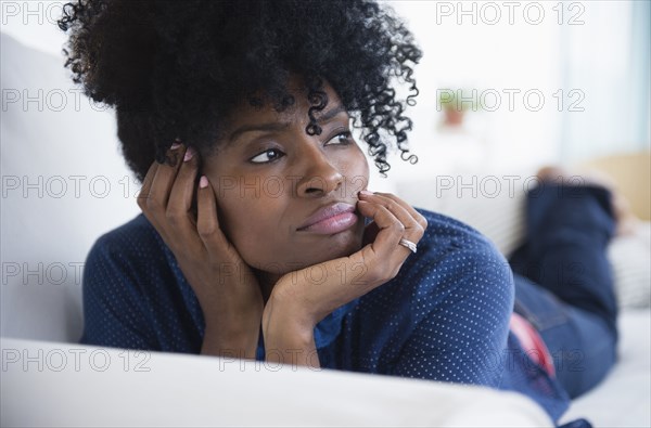 Black woman laying on sofa