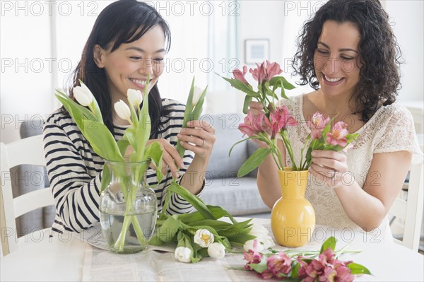 Women arranging flowers together