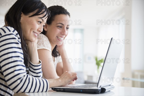 Women using laptop together