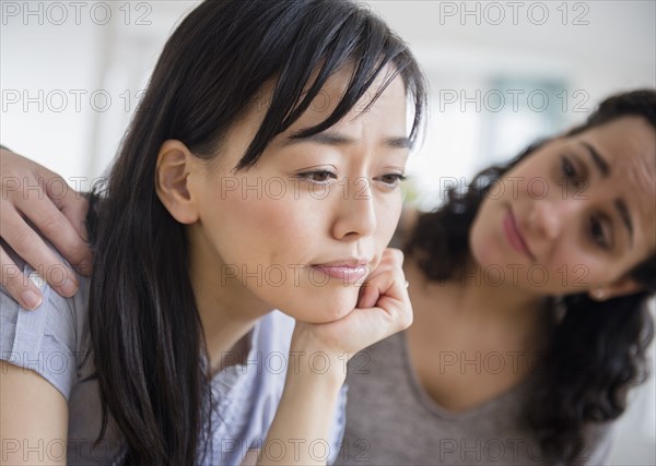 Woman comforting sad friend