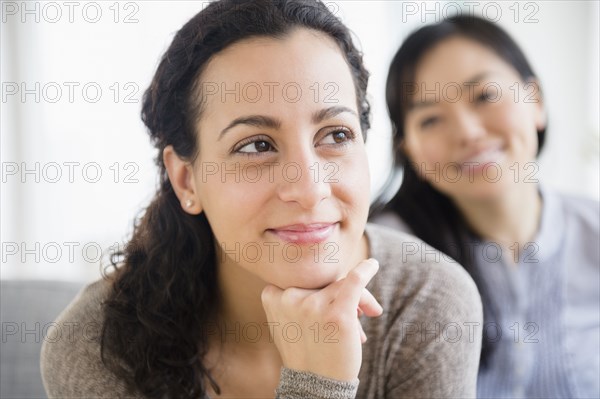 Women sitting together on sofa