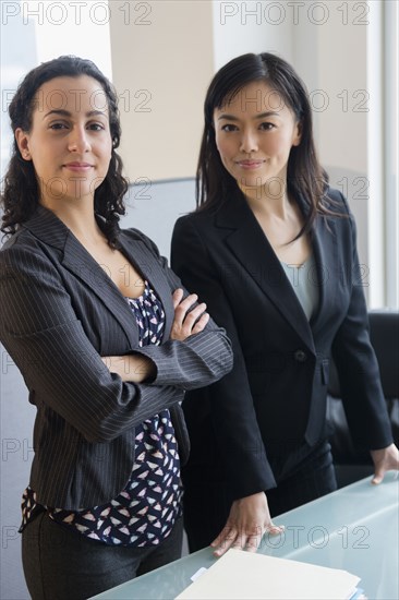 Businesswomen smiling together in office