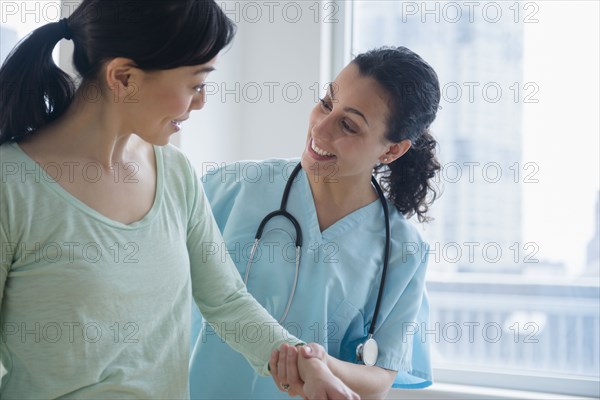 Nurse helping patient in hospital