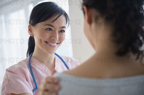 Nurse talking to patient in hospital