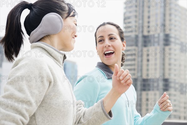 Women jogging together in city