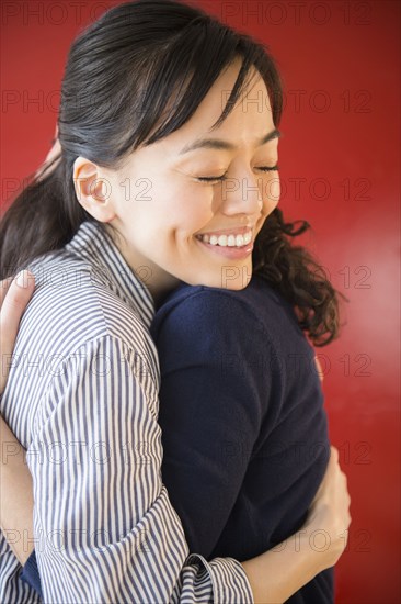 Smiling women hugging