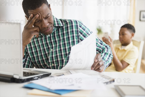 Anxious father paying bills online
