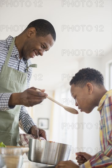 Father and son cooking together in kitchen