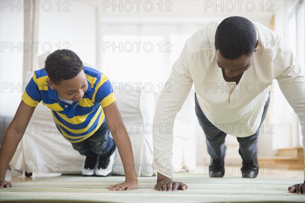 Father and son doing push ups together