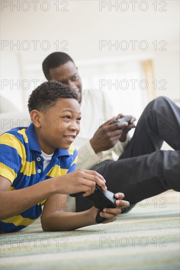 Father and son playing video games together