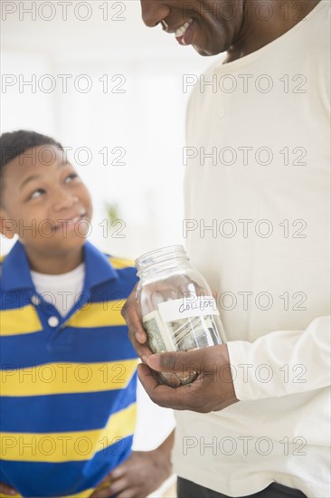 Father and son saving money for college