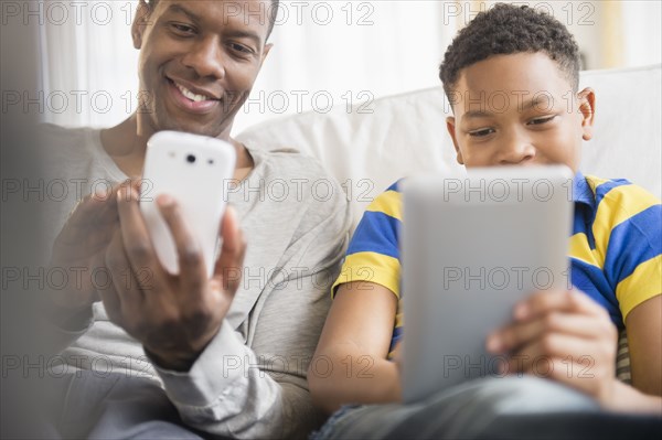 Father and son using technology together