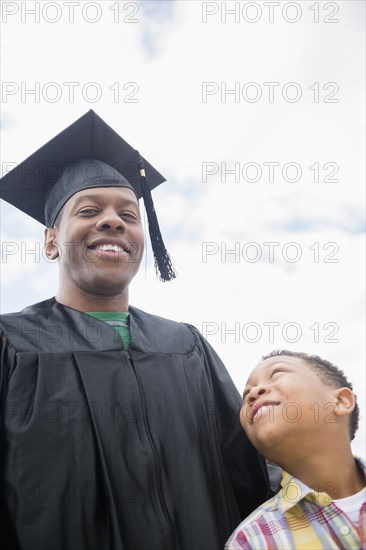 Graduating father smiling with son