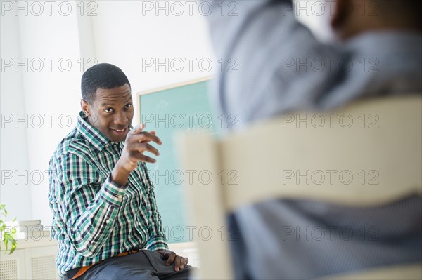 Teacher pointing at student in classroom