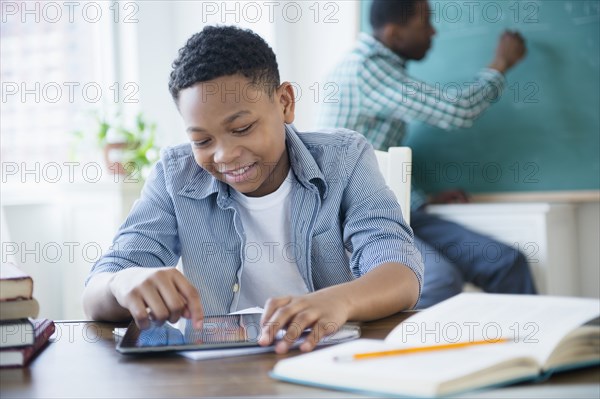 Student using tablet computer in classroom